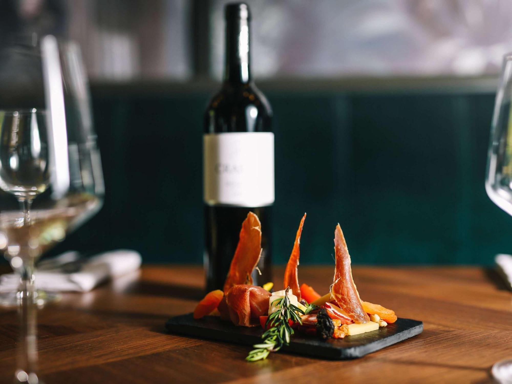 Sofitel Lisbon Liberdade Hotel Exterior photo A bottle of wine and a plate of tapas